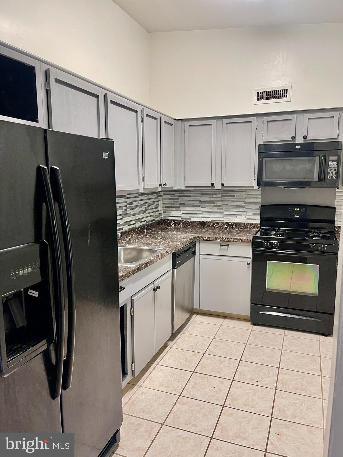 60201 Delaire Landing Road, Unit 201 Philadelphia, PA 19114 - Photo 12 of 49 a kitchen with stainless steel appliances granite countertop a refrigerator stove and sink