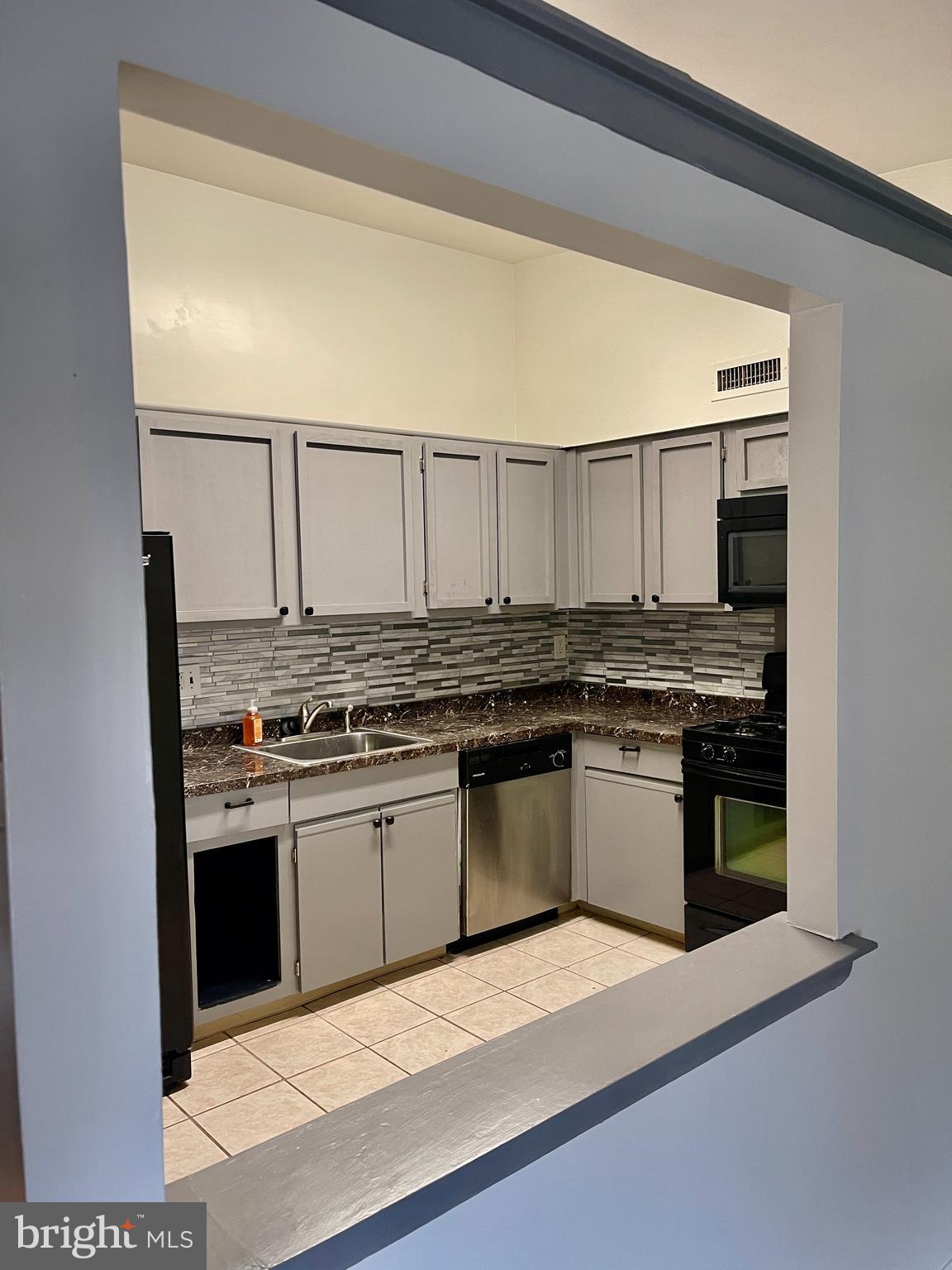 60201 Delaire Landing Road, Unit 201 Philadelphia, PA 19114 - Photo 14 of 49 a kitchen with stainless steel appliances granite countertop a stove and a sink
