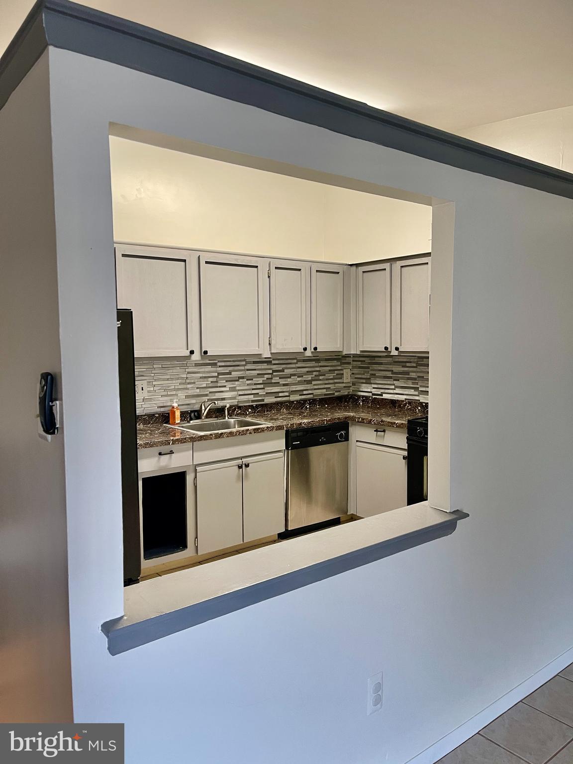 60201 Delaire Landing Road, Unit 201 Philadelphia, PA 19114 - Photo 15 of 49 a kitchen with stainless steel appliances granite countertop a stove and a microwave