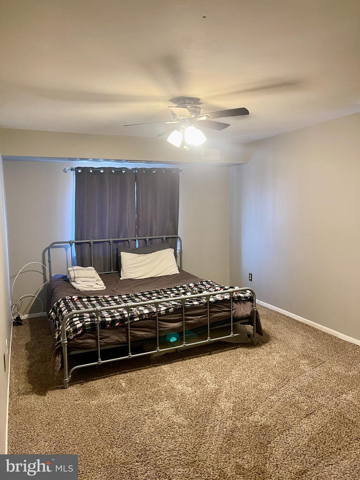 60201 Delaire Landing Road, Unit 201 Philadelphia, PA 19114 - Photo 22 of 49 a bed sitting in a bedroom next to a lamp