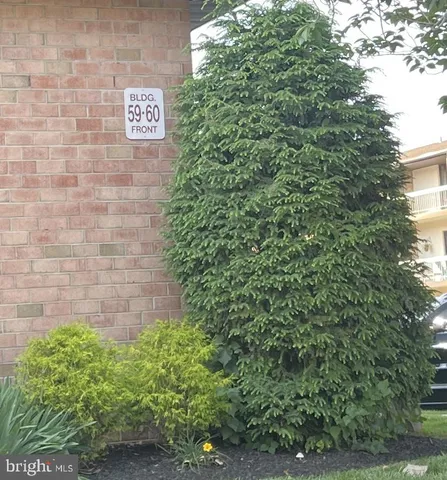 a brick building with a tree in the background