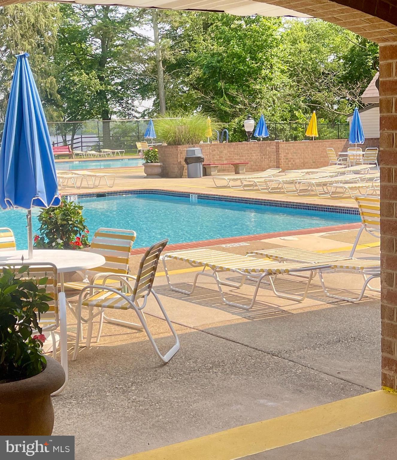 60201 Delaire Landing Road, Unit 201 Philadelphia, PA 19114 - Photo 37 of 49 a view of a swimming pool with a lounge chairs