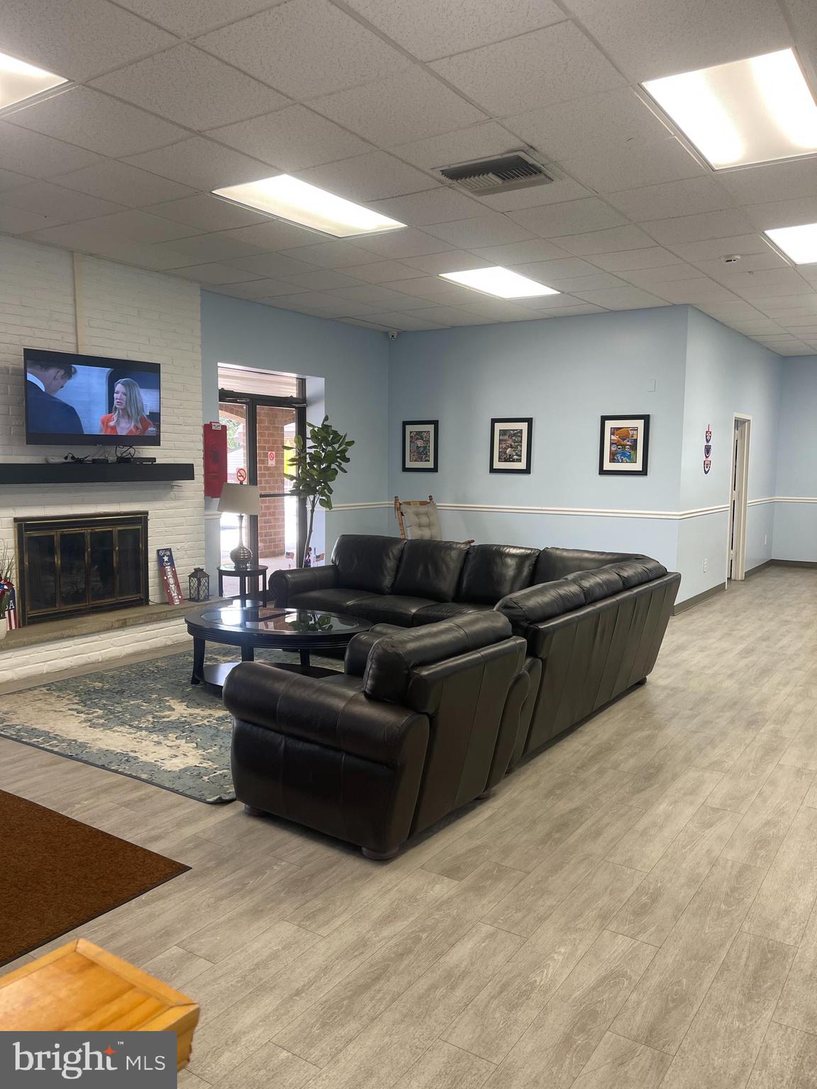60201 Delaire Landing Road, Unit 201 Philadelphia, PA 19114 - Photo 38 of 49 a living room with furniture a fireplace and a flat screen tv