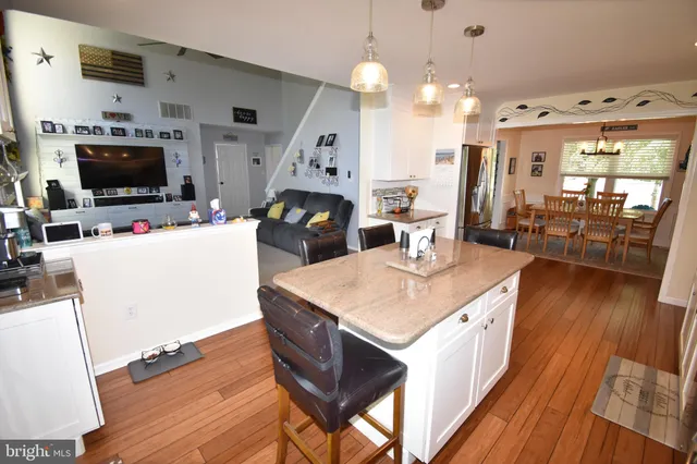 a kitchen with a refrigerator and a stove top oven