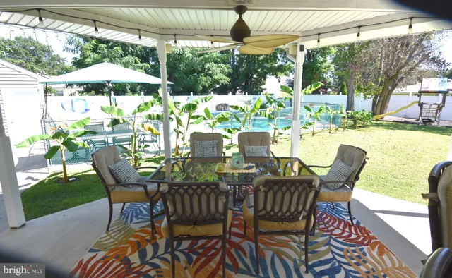 a dining room with furniture a rug and wooden floor