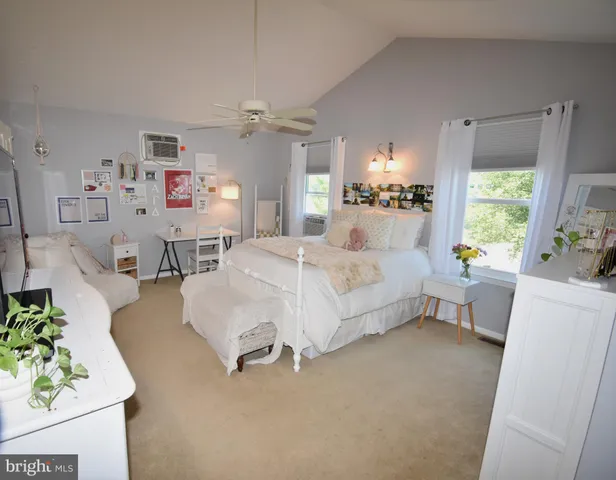 a bedroom with a large bed and a window