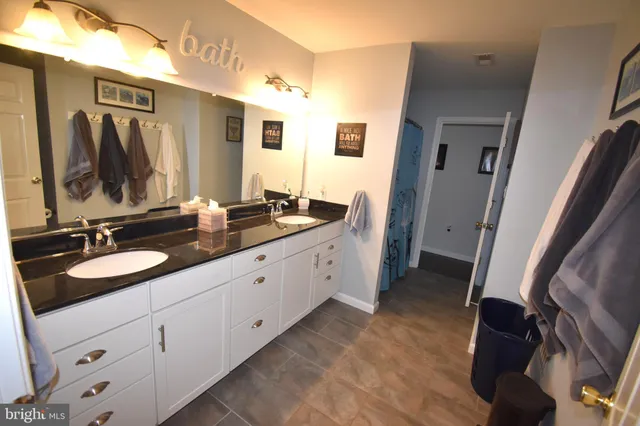 a spacious bedroom with a bed and a chandelier