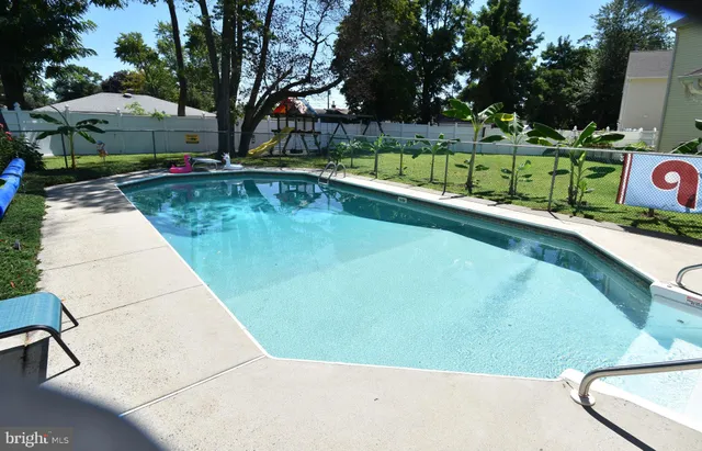 a front view of a house with swimming pool having outdoor seating