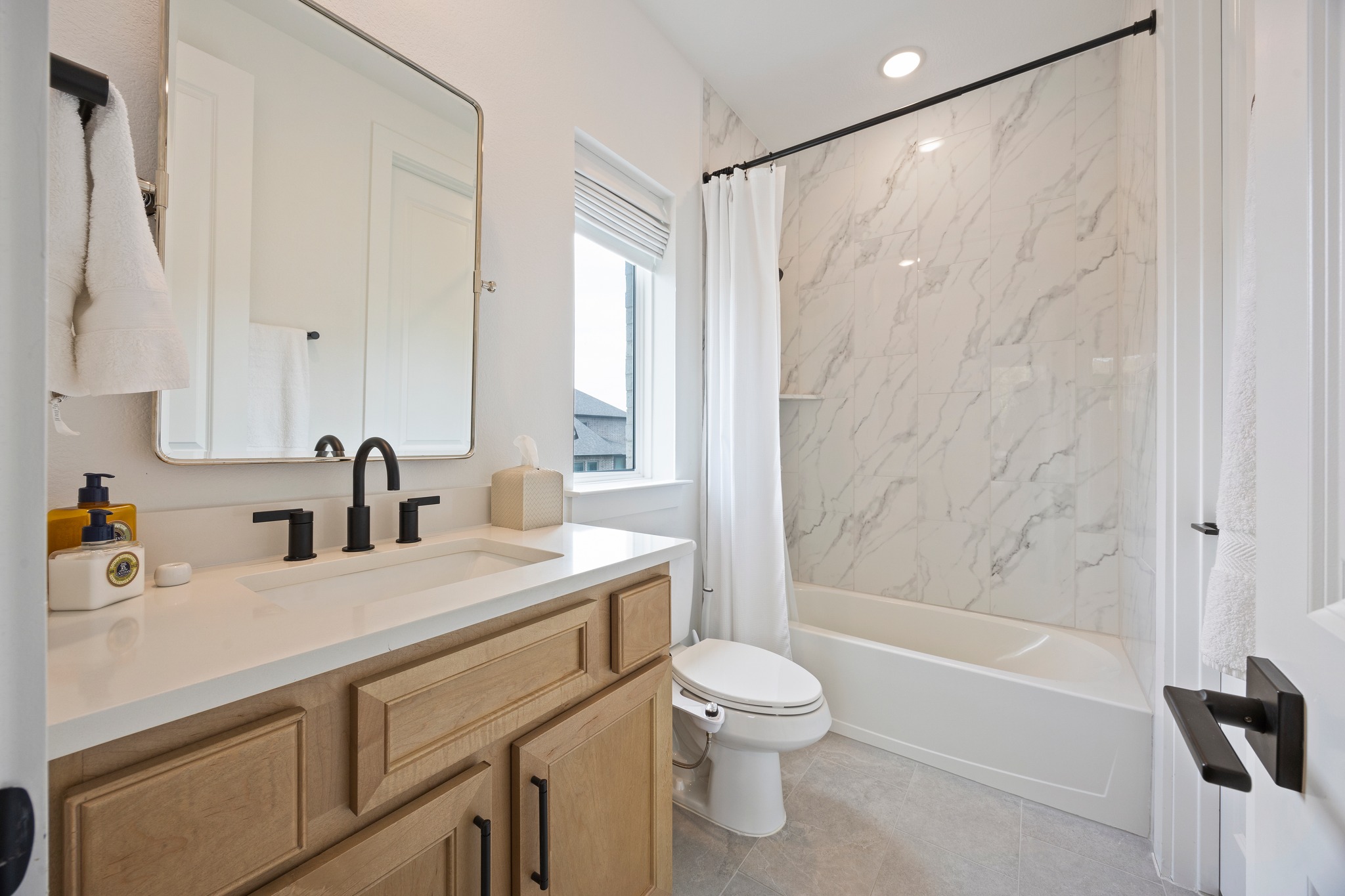 1204 Addison Lane Georgetown, TX 78628 - Photo 18 of 35 a bathroom with a sink a toilet and a bathtub