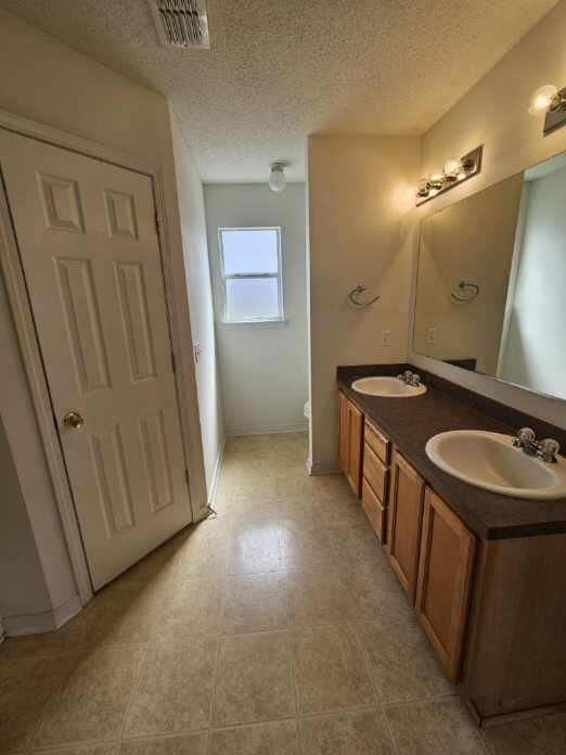 294 Limestone Circle Crestview, FL 32539 - Photo 15 of 19 a bathroom with 2 sink and a mirror