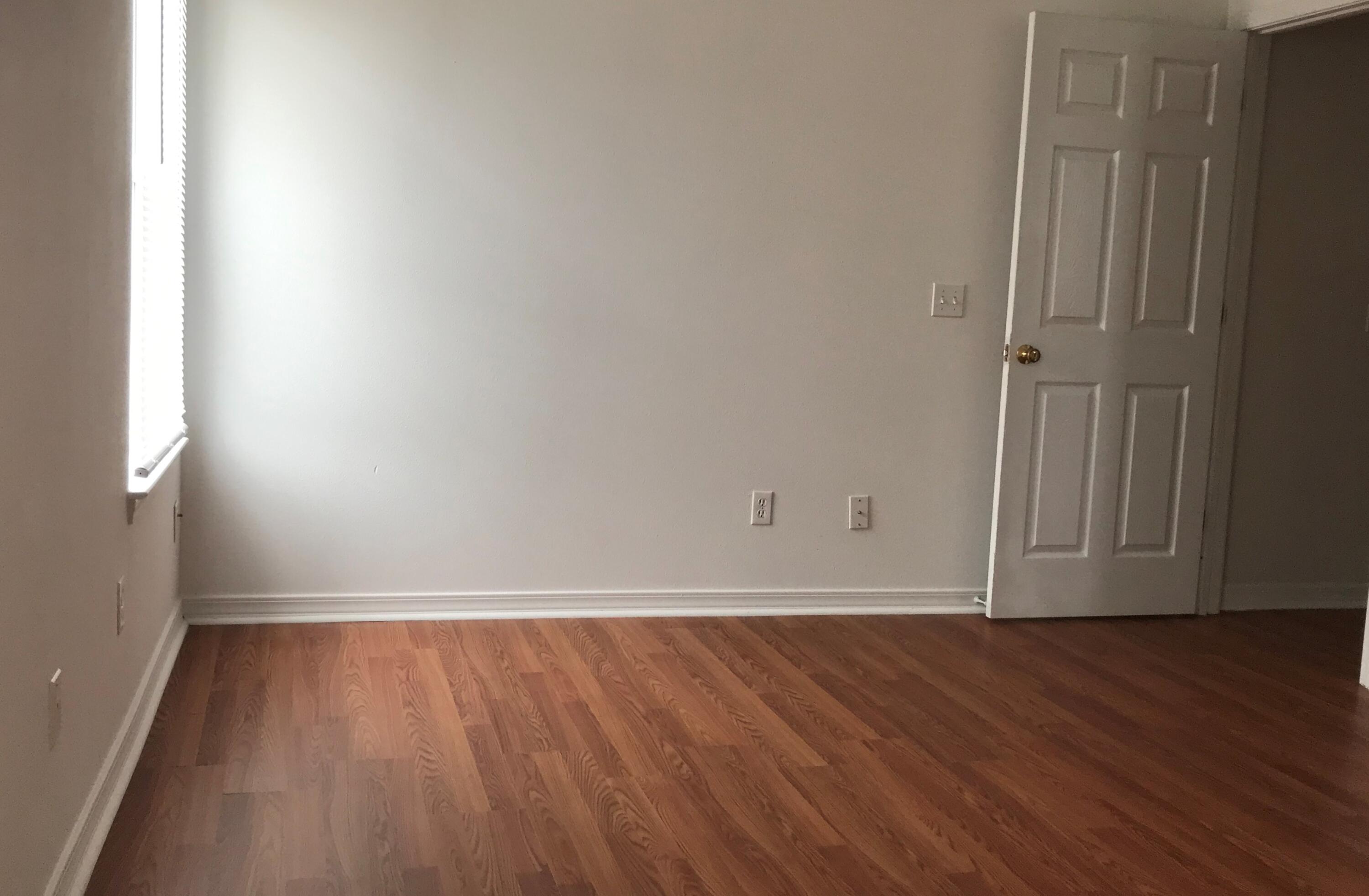 294 Limestone Circle Crestview, FL 32539 - Photo 18 of 19 a view of an empty room with wooden floor and a window