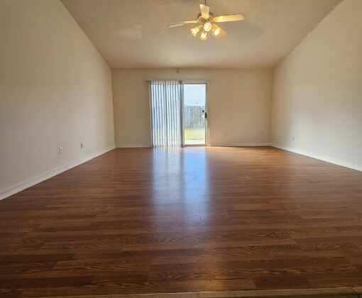 294 Limestone Circle Crestview, FL 32539 - Photo 4 of 19 a view of an empty room with wooden floor and a window