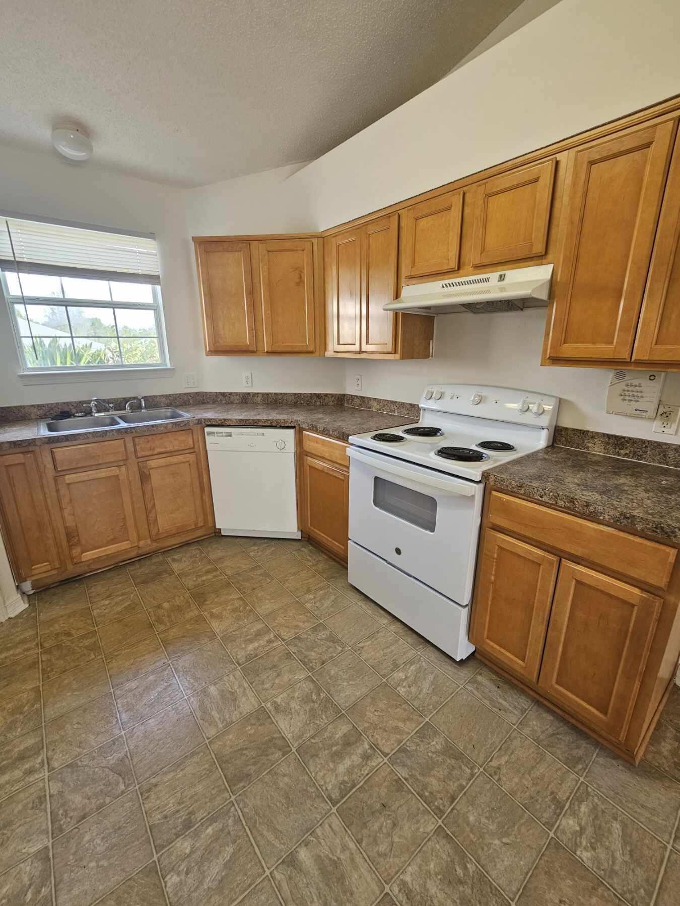 294 Limestone Circle Crestview, FL 32539 - Photo 9 of 19 a kitchen with stainless steel appliances granite countertop a stove sink and cabinets