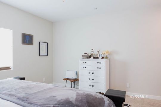 411 Abigail Street Ridgecrest, CA 93555 - Photo 20 of 39 a bedroom with a bed and cabinets