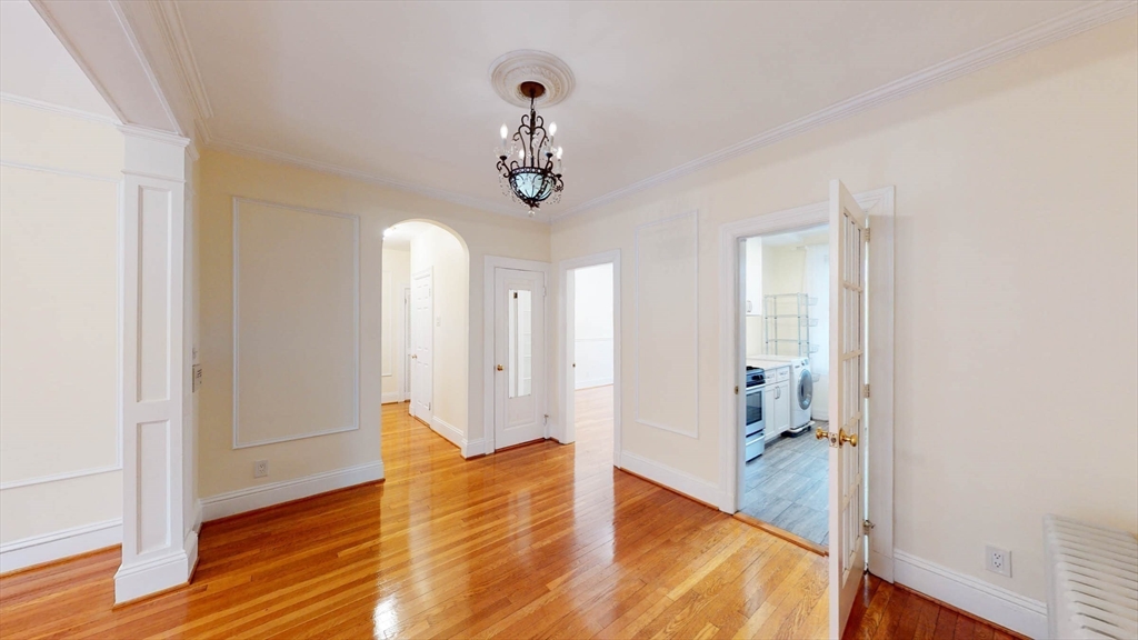 311 Tappan Street, Unit 3 Brookline, MA 02445 - Photo 12 of 35 wooden floor in an empty room with a window