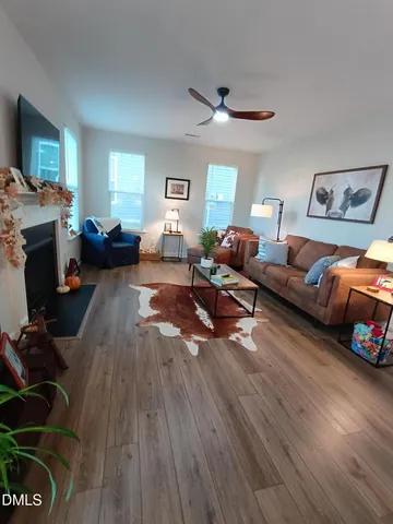 a living room with furniture a fireplace and a window