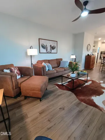 a living room with furniture and wooden floor