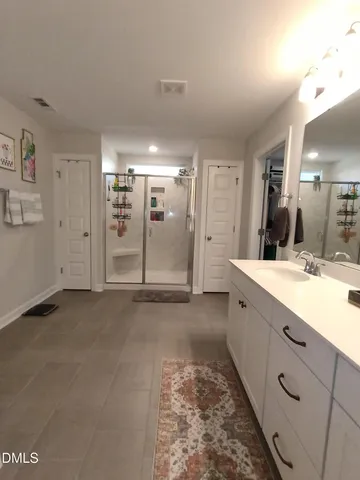 a room with a sink vanity and mirror