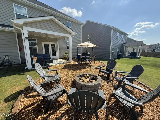 a view of a backyard with sitting area and furniture