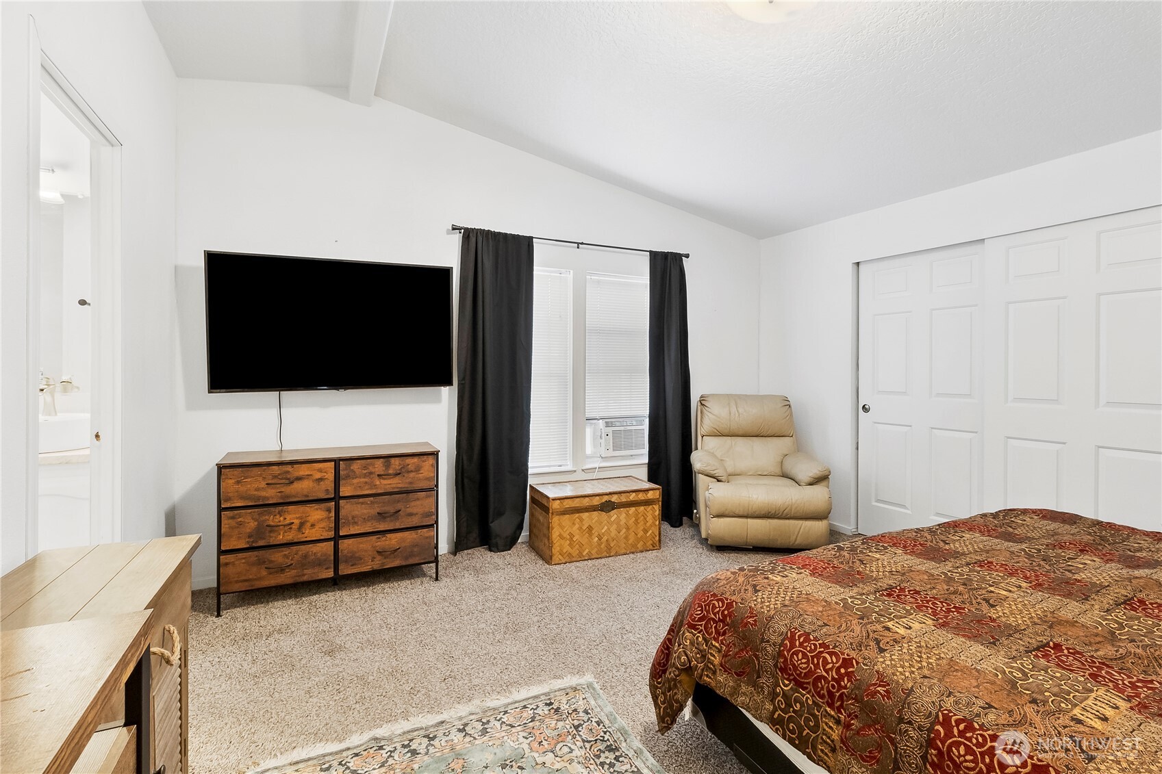 1200 Lincoln Street, Unit 193 Bellingham, WA 98229 - Photo 14 of 18 a bedroom with a bed and flat screen tv