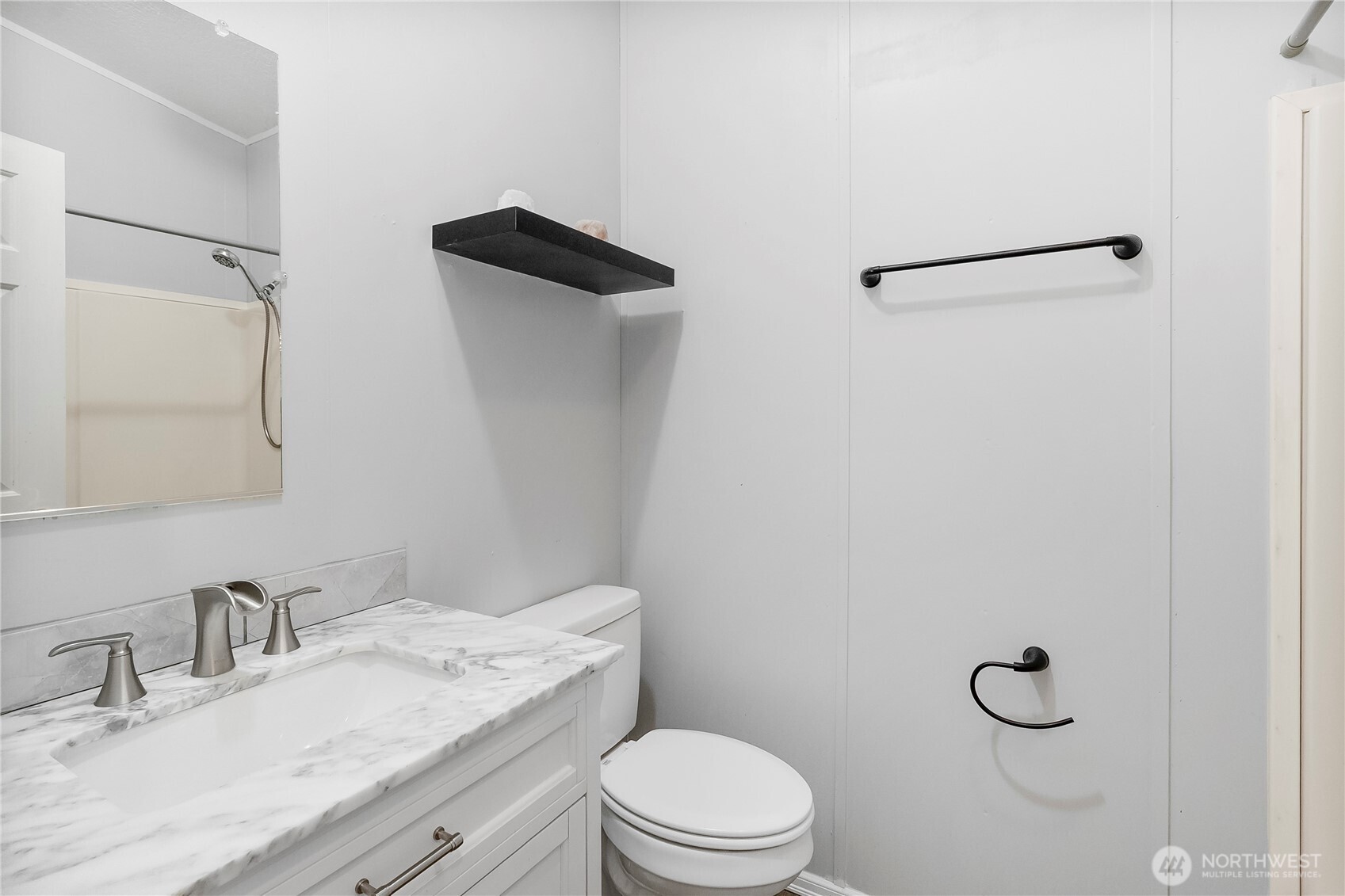 1200 Lincoln Street, Unit 193 Bellingham, WA 98229 - Photo 16 of 18 a bathroom with a granite countertop sink toilet and a mirror