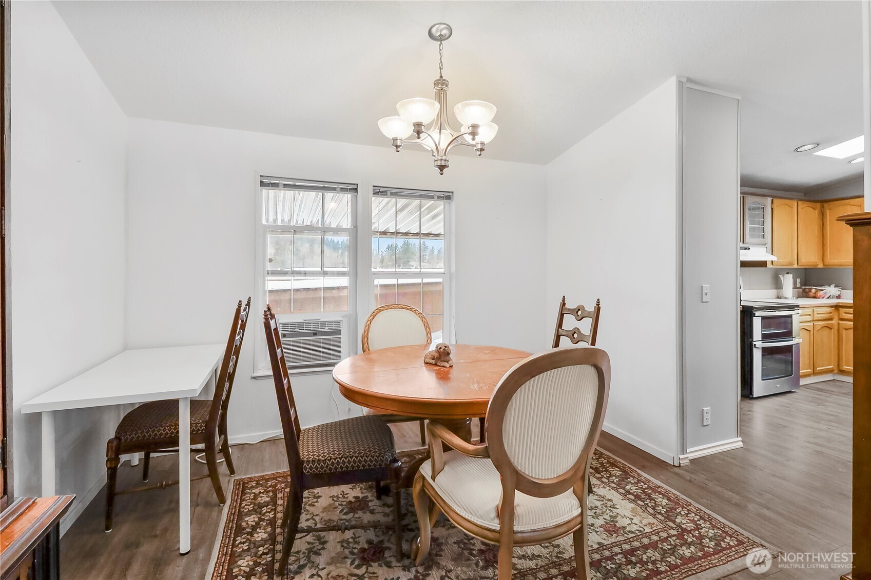 1200 Lincoln Street, Unit 193 Bellingham, WA 98229 - Photo 10 of 18 a dining room with furniture a chandelier and wooden floor