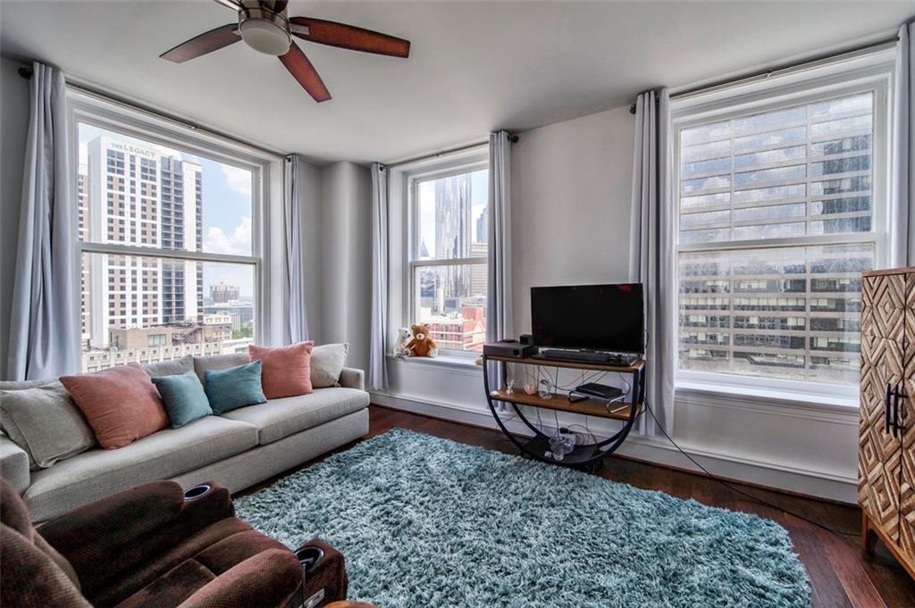 57 Forsyth Street Northwest, Unit 12B Atlanta, GA 30303 - Photo 14 of 38 a living room with furniture a flat screen tv and a large window