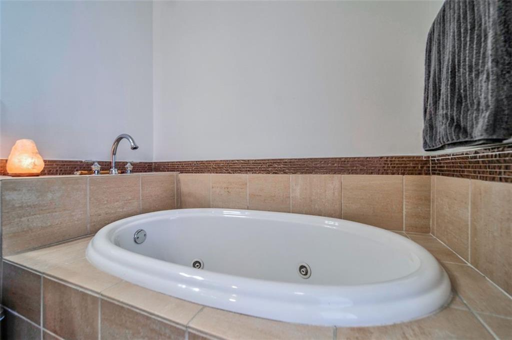 57 Forsyth Street Northwest, Unit 12B Atlanta, GA 30303 - Photo 21 of 38 a bath tub sitting in a bathroom