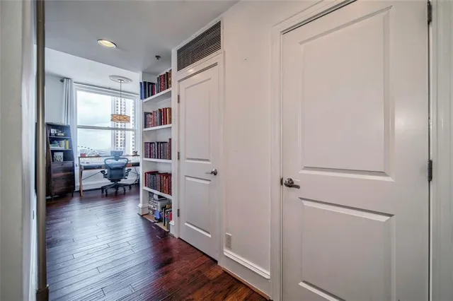 a view of living room with furniture and wooden floor