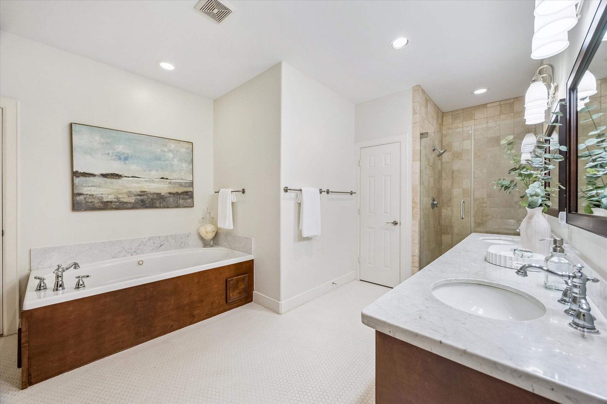 4010 Milton Street Houston, TX 77005 - Photo 23 of 49 The spacious primary bath includes marble countertops, a soaking tub, and an oversized walk-in shower.