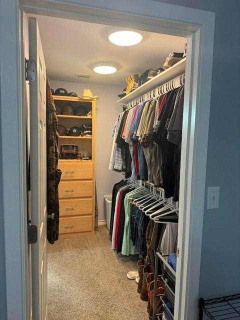 1387 Hickory Street Rhome, TX 76078 - Photo 33 of 36 Barndominium - Walk-in closet with overhead lighting, built-in shelving, and wood-finish drawer storage.