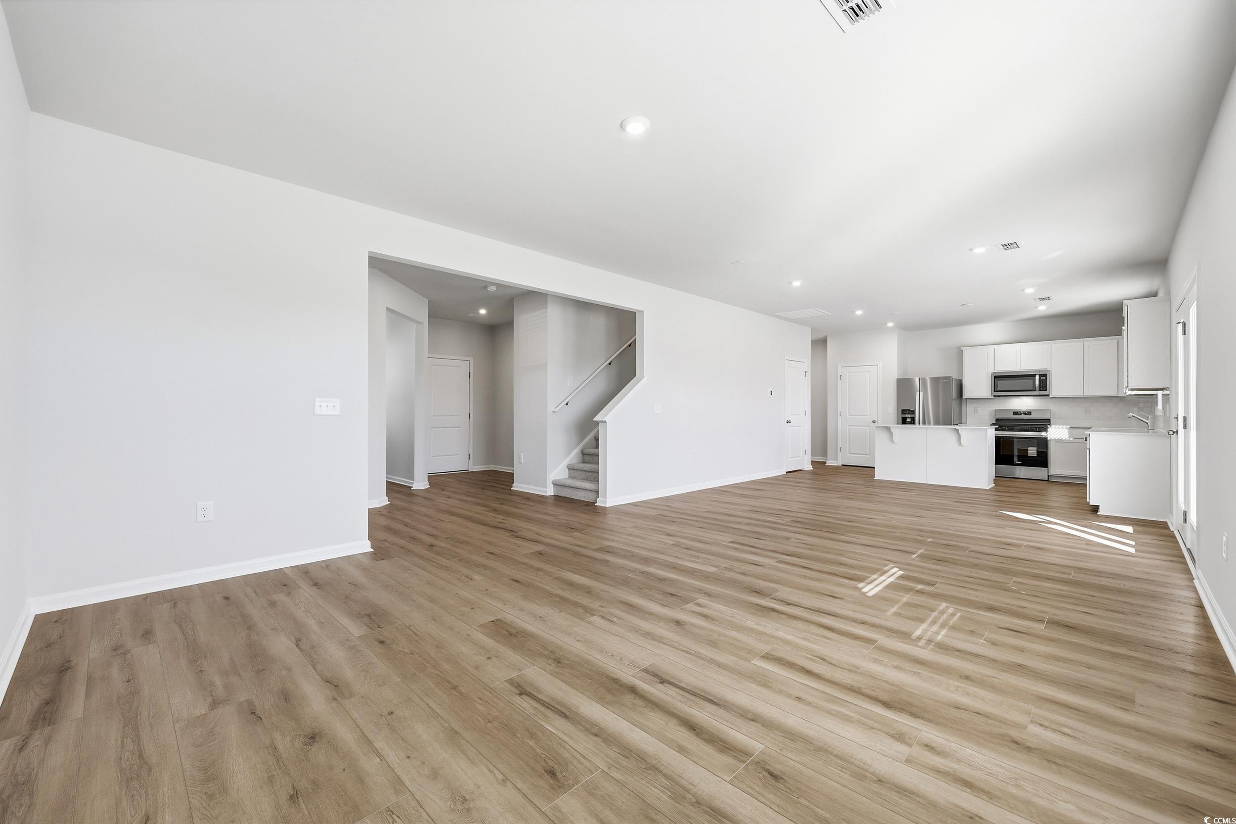 3055 Visionary Drive Myrtle Beach, SC 29588 - Photo 11 of 31 Unfurnished living room featuring light wood-style floors, stairway, and recessed lighting