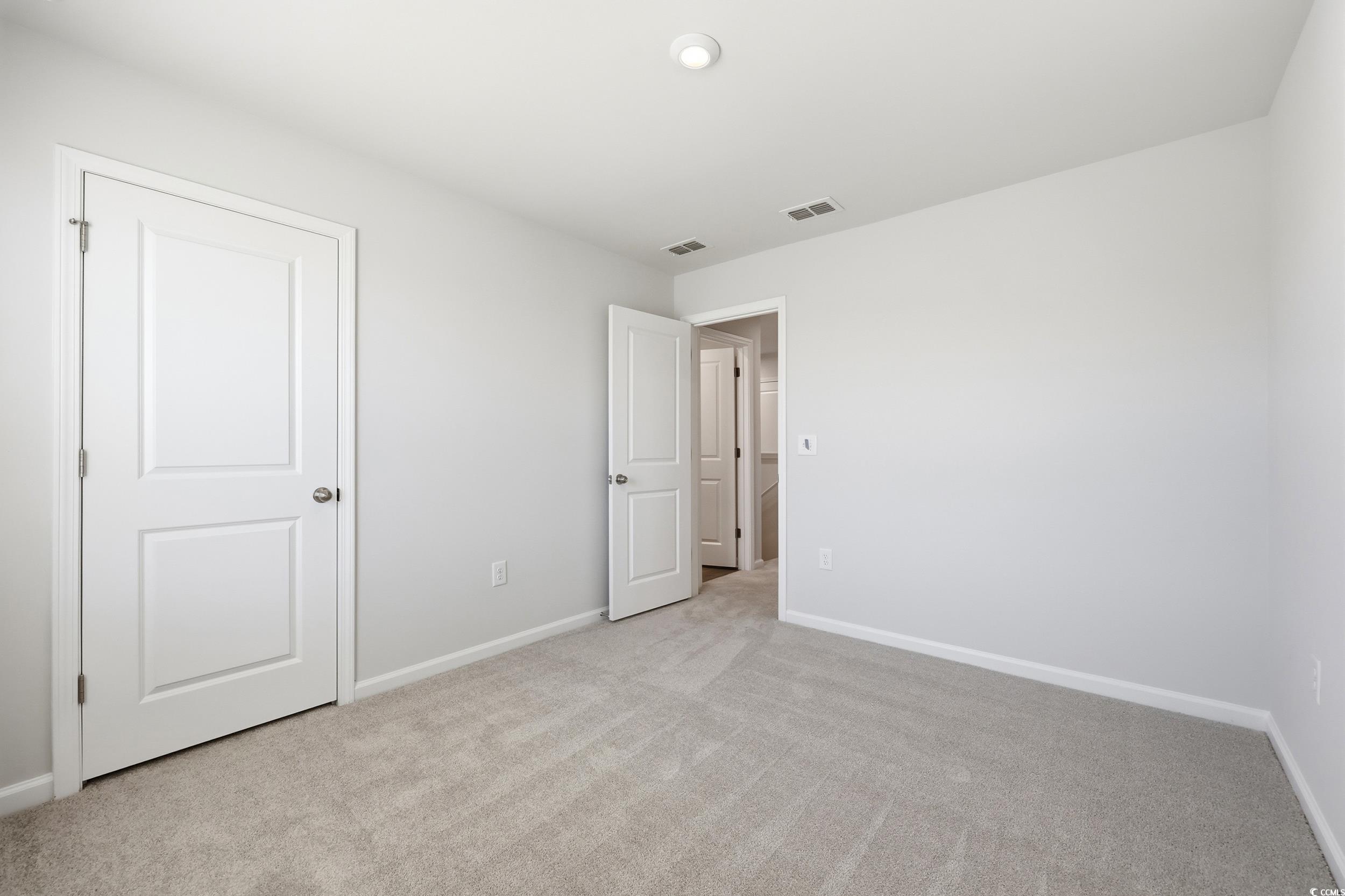 3055 Visionary Drive Myrtle Beach, SC 29588 - Photo 19 of 31 Unfurnished bedroom featuring light carpet and baseboards