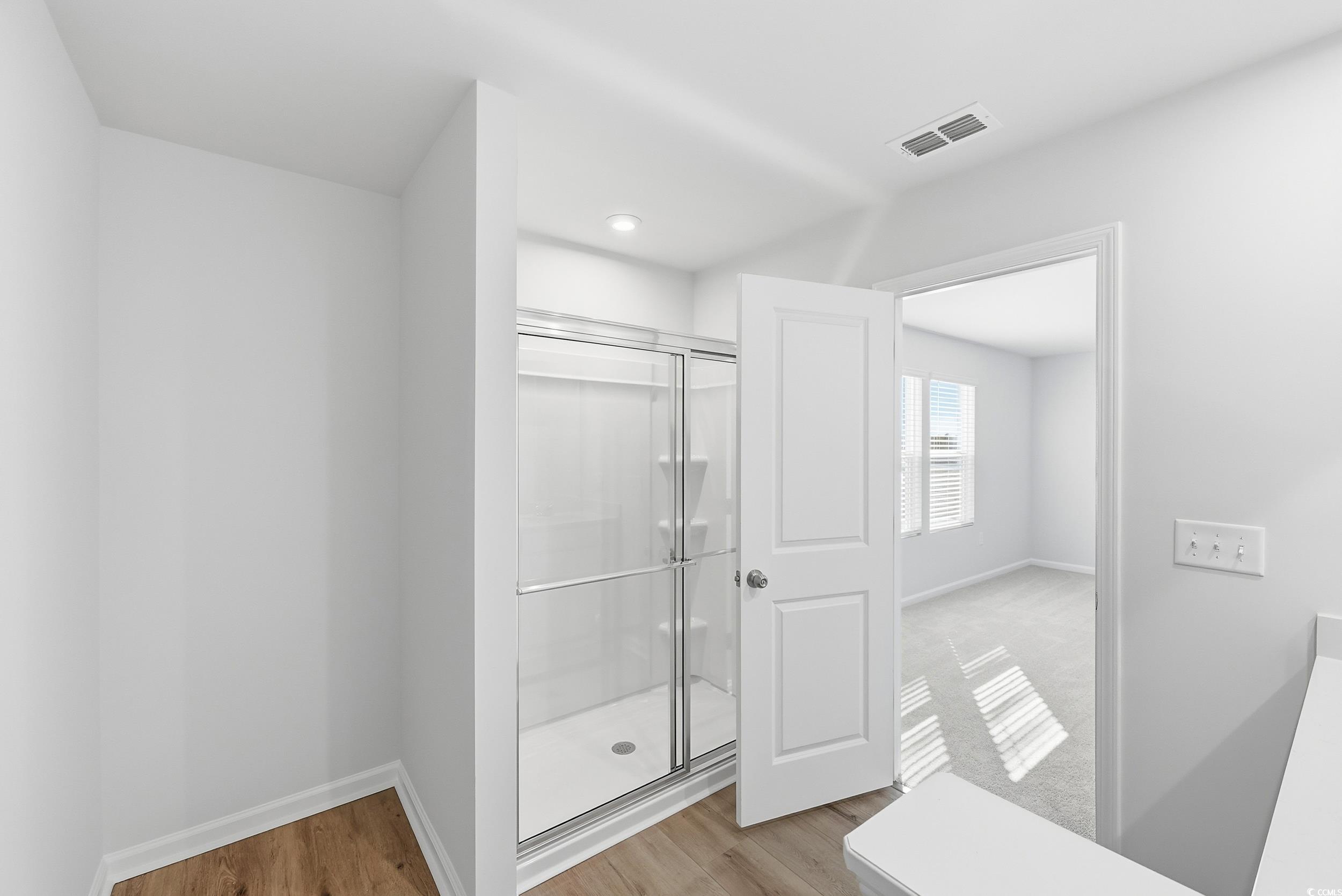 3055 Visionary Drive Myrtle Beach, SC 29588 - Photo 28 of 31 Bathroom featuring a stall shower and light wood-style floors