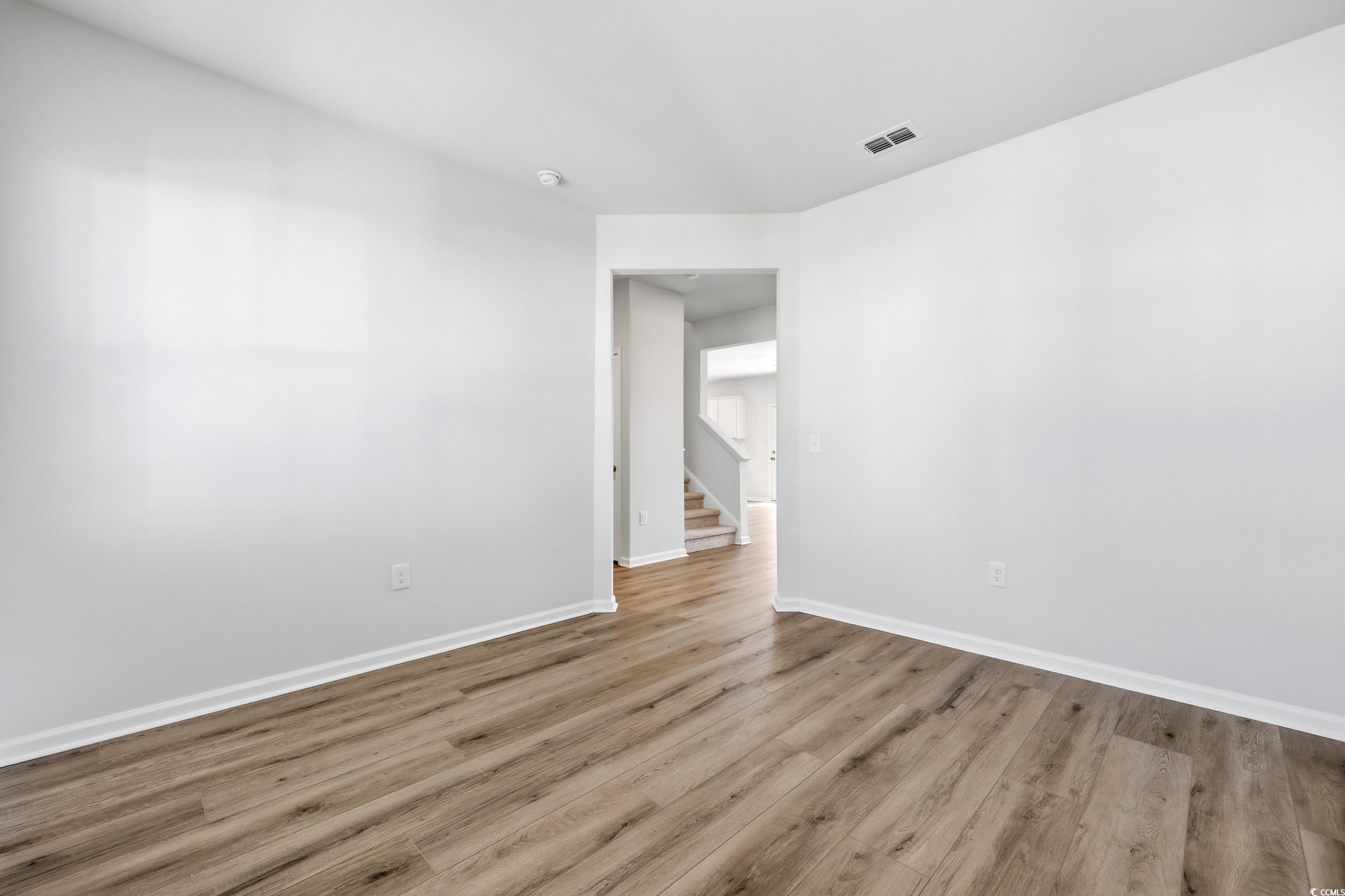 3055 Visionary Drive Myrtle Beach, SC 29588 - Photo 6 of 31 Unfurnished room with wood finished floors and stairway