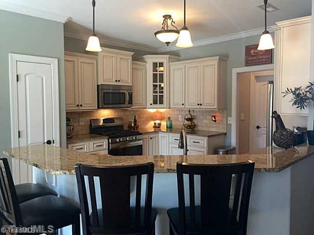 5083 Peppertree Road Clemmons, NC 27012 - Photo 3 of 16 Kitchen. Light cabinetry, granite tops, gas range, seating around bar