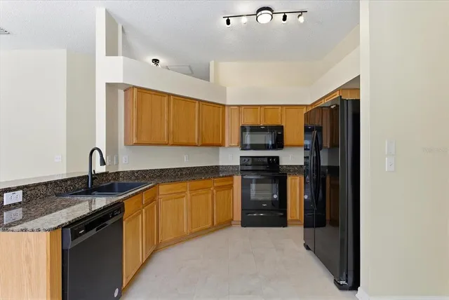 a kitchen with a refrigerator and cabinets