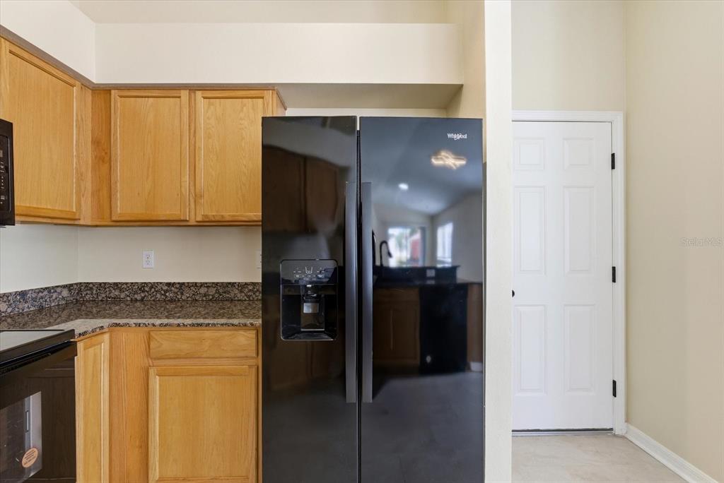 12923 Fieldmoor Court Riverview, FL 33579 - Photo 16 of 37 a kitchen with a refrigerator and cabinets
