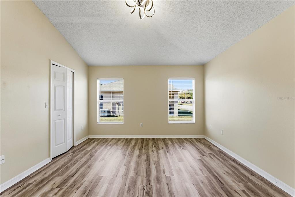 12923 Fieldmoor Court Riverview, FL 33579 - Photo 19 of 37 an empty room with wooden floor and windows