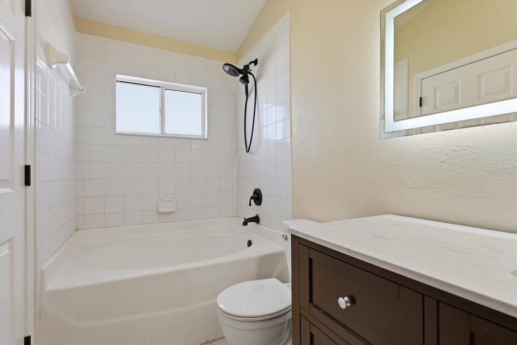 12923 Fieldmoor Court Riverview, FL 33579 - Photo 23 of 37 a bathroom with a sink a toilet and a bathtub