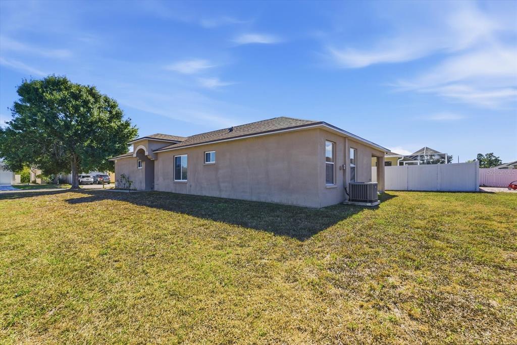 12923 Fieldmoor Court Riverview, FL 33579 - Photo 24 of 37 a backyard of a house with large trees
