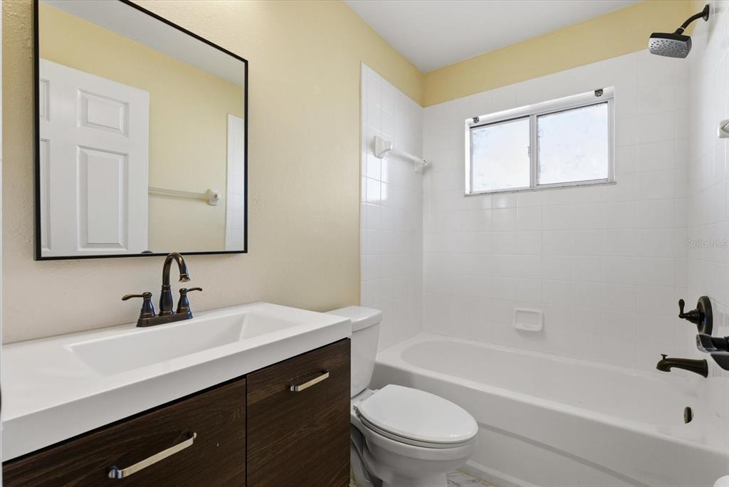 12923 Fieldmoor Court Riverview, FL 33579 - Photo 7 of 37 a bathroom with a sink a toilet and shower
