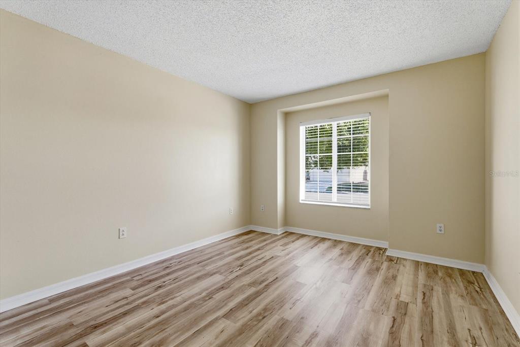 12923 Fieldmoor Court Riverview, FL 33579 - Photo 8 of 37 a view of an empty room with wooden floor and a window