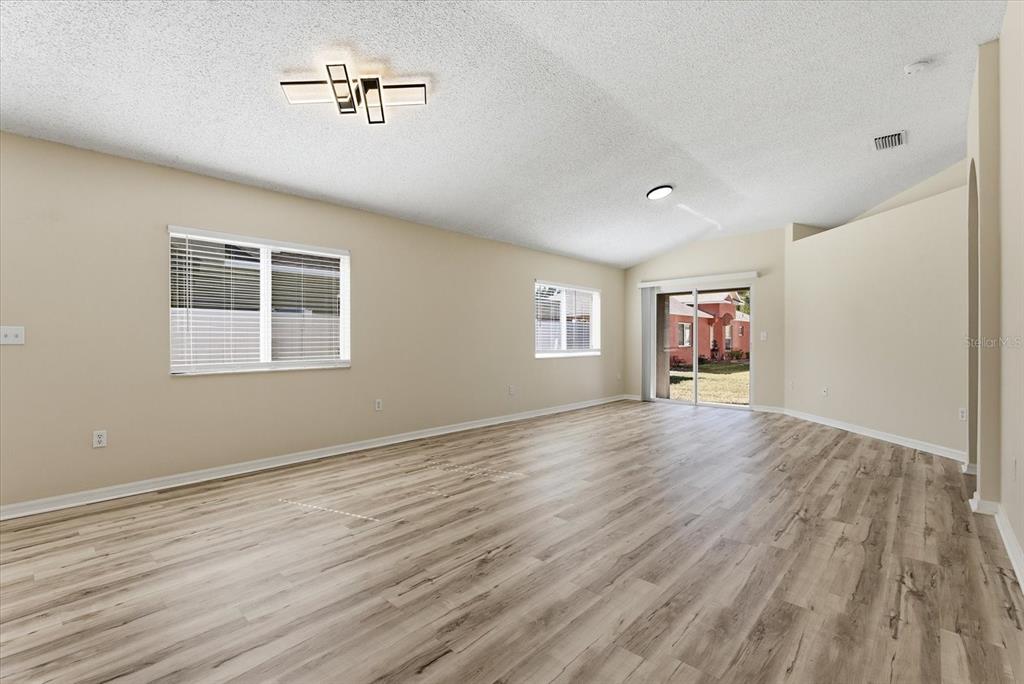 12923 Fieldmoor Court Riverview, FL 33579 - Photo 10 of 37 a view of empty room with wooden floor and fan