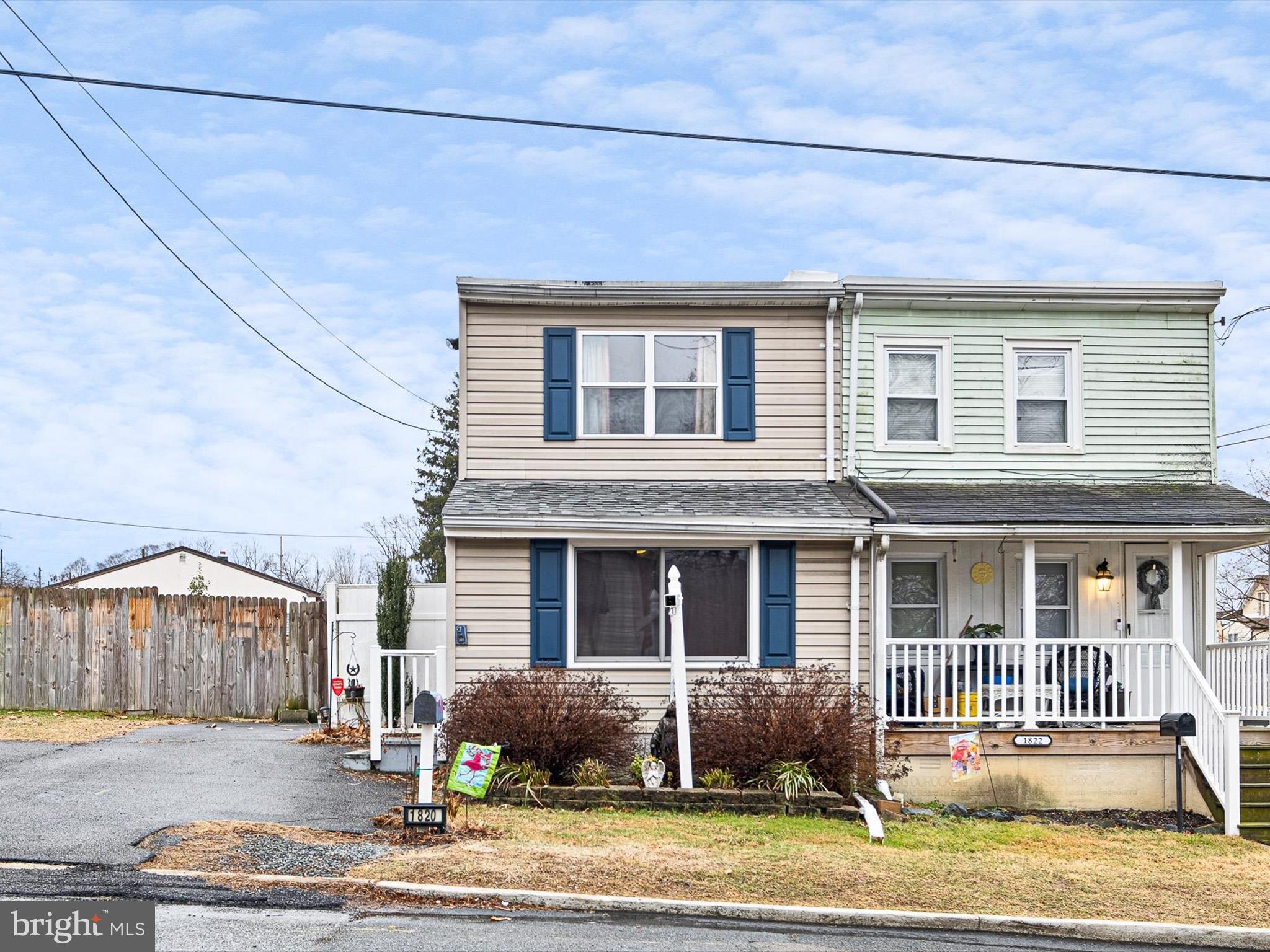 a front view of a house with a yard and outdoor seating