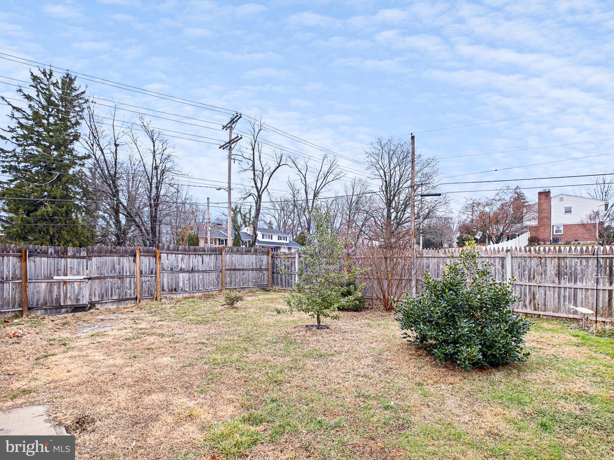 1820 Newport Road Wilmington, DE 19808 - Photo 19 of 20 a view of a backyard with large tree and wooden fence