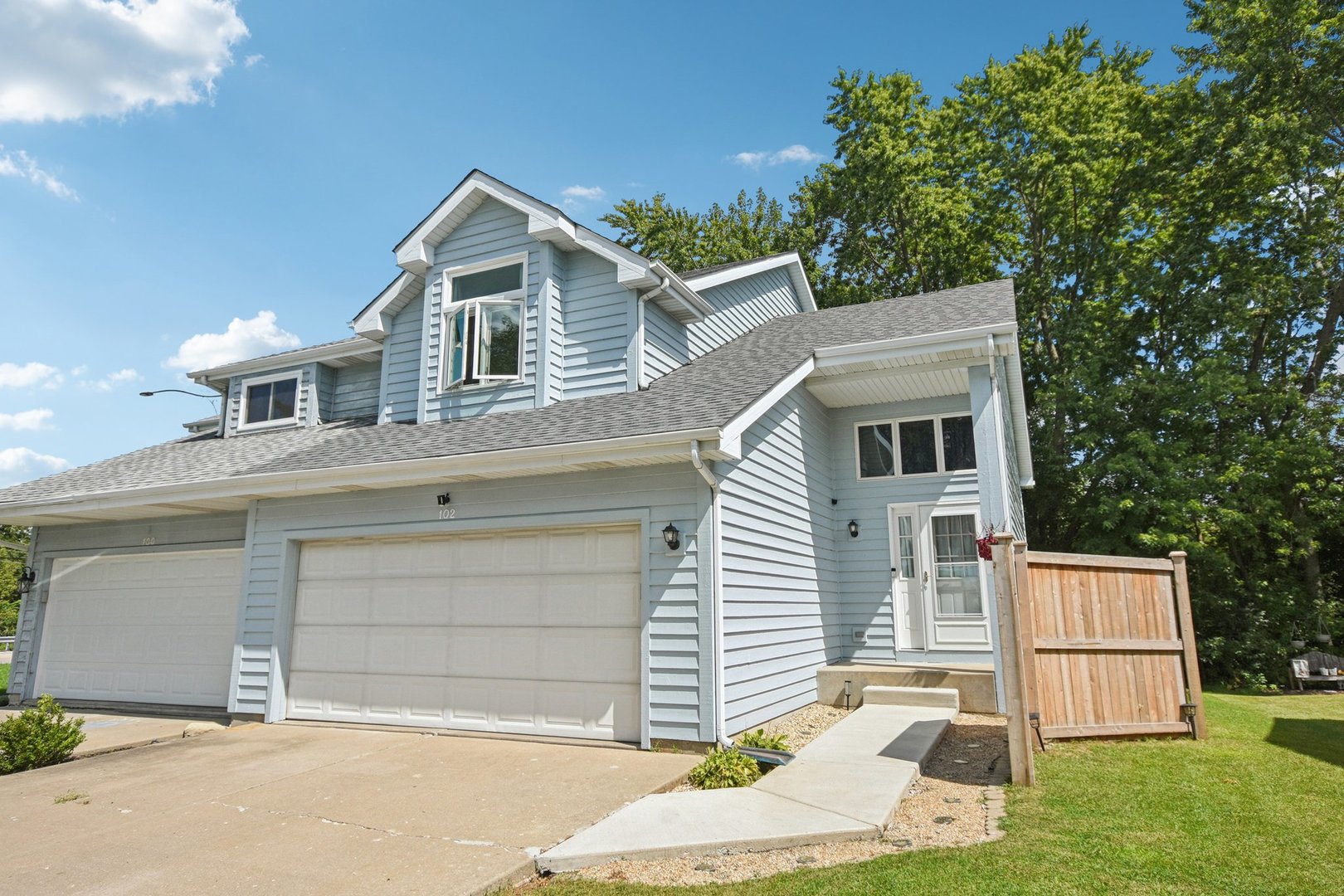 102 Ravinia Drive Shorewood, IL 60404 - Photo 2 of 30 a front view of a house with a yard and garage