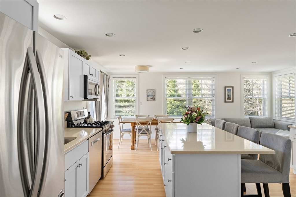 13 Young Street Edgartown, MA 02539 - Photo 3 of 29 a kitchen with stainless steel appliances a dining table chairs and a large window