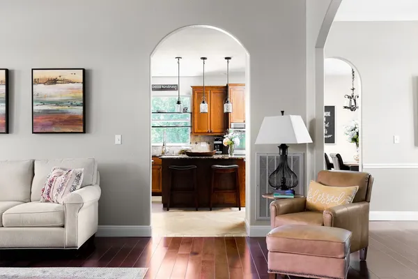 a living room with furniture a lamp and a window