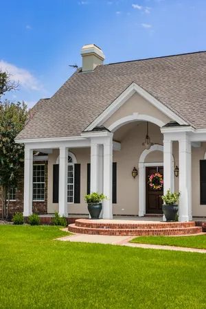 a view of a house with a swimming pool and a yard